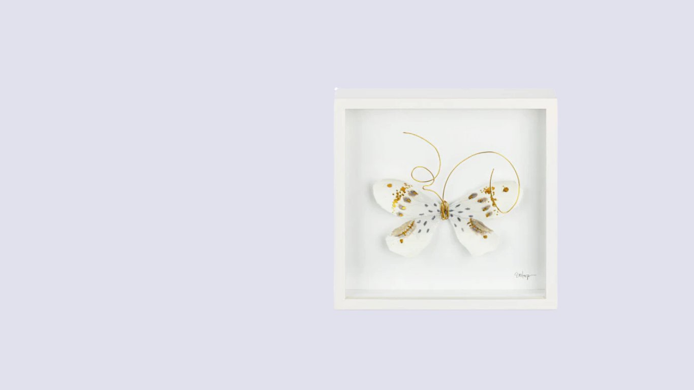 Framed artwork of a butterfly on a light purple background